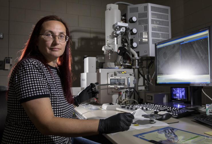 <p>Elena Plis, a GTRI senior research engineer, takes SEM measurements of materials being evaluated as part of the MISSE-16 program (Credit: Sean McNeil, GTRI)</p>