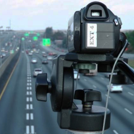 A video camera overlooks a freeway to survey traffic usage patterns.