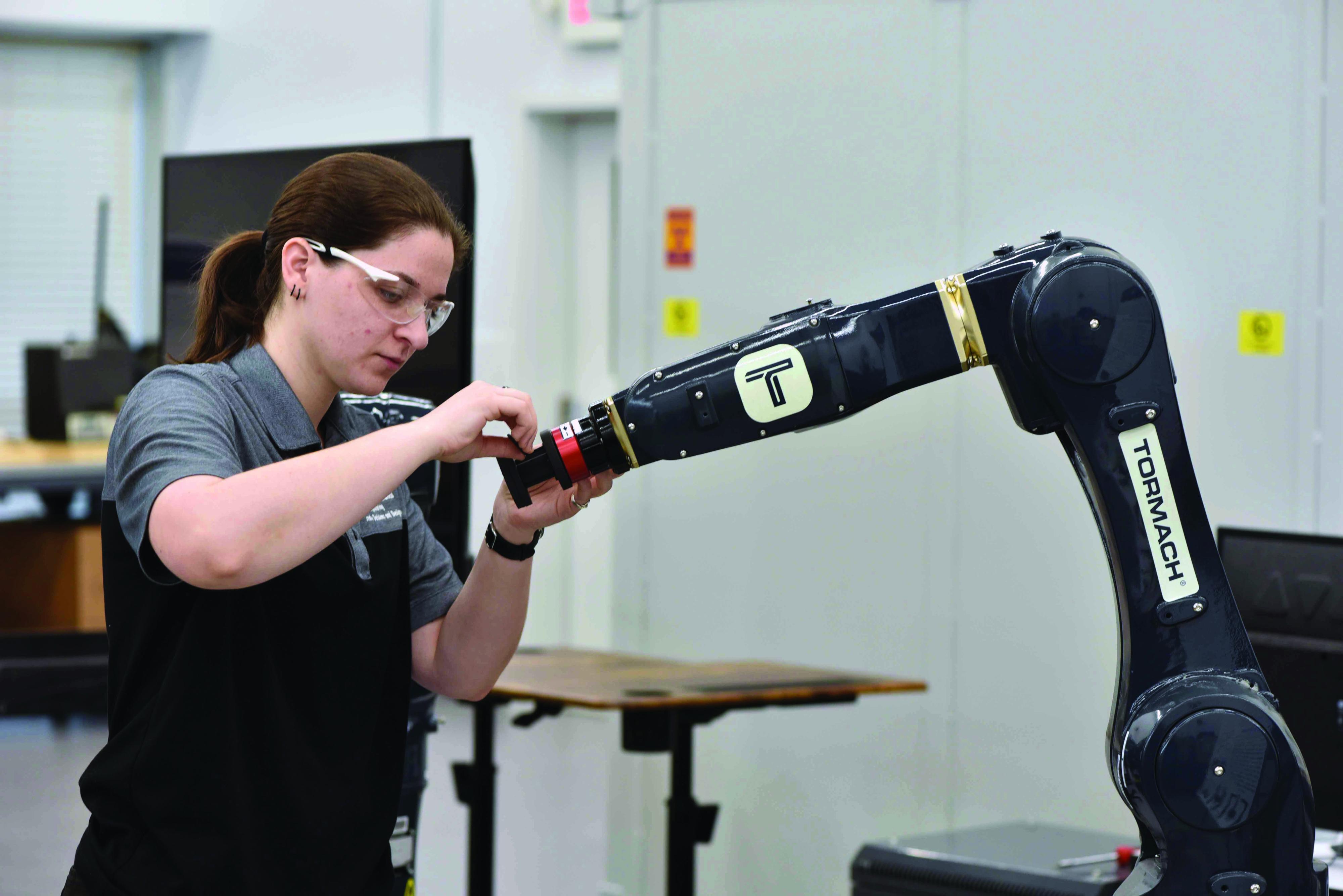 Researcher working with a Robotics Arm