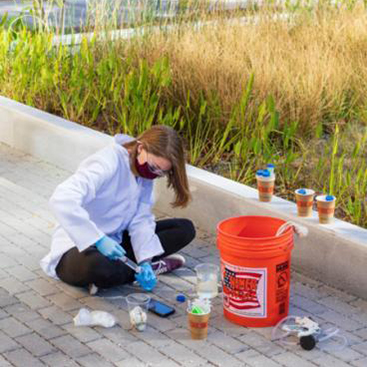Student samples treated greywater from Kendeda building reed bed.