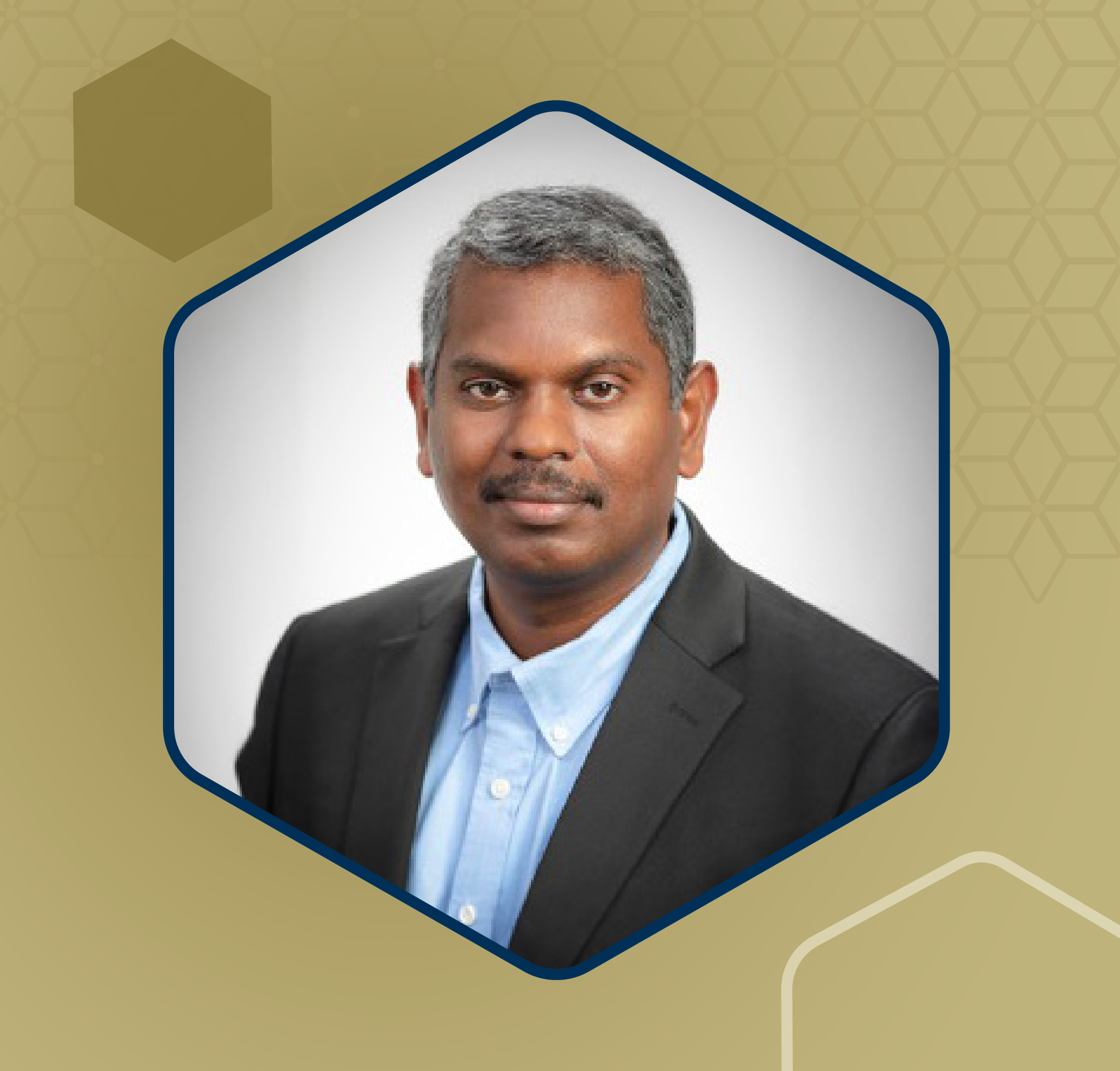 Professional headshot of an individual wearing a dark blazer and light blue shirt against a white background.