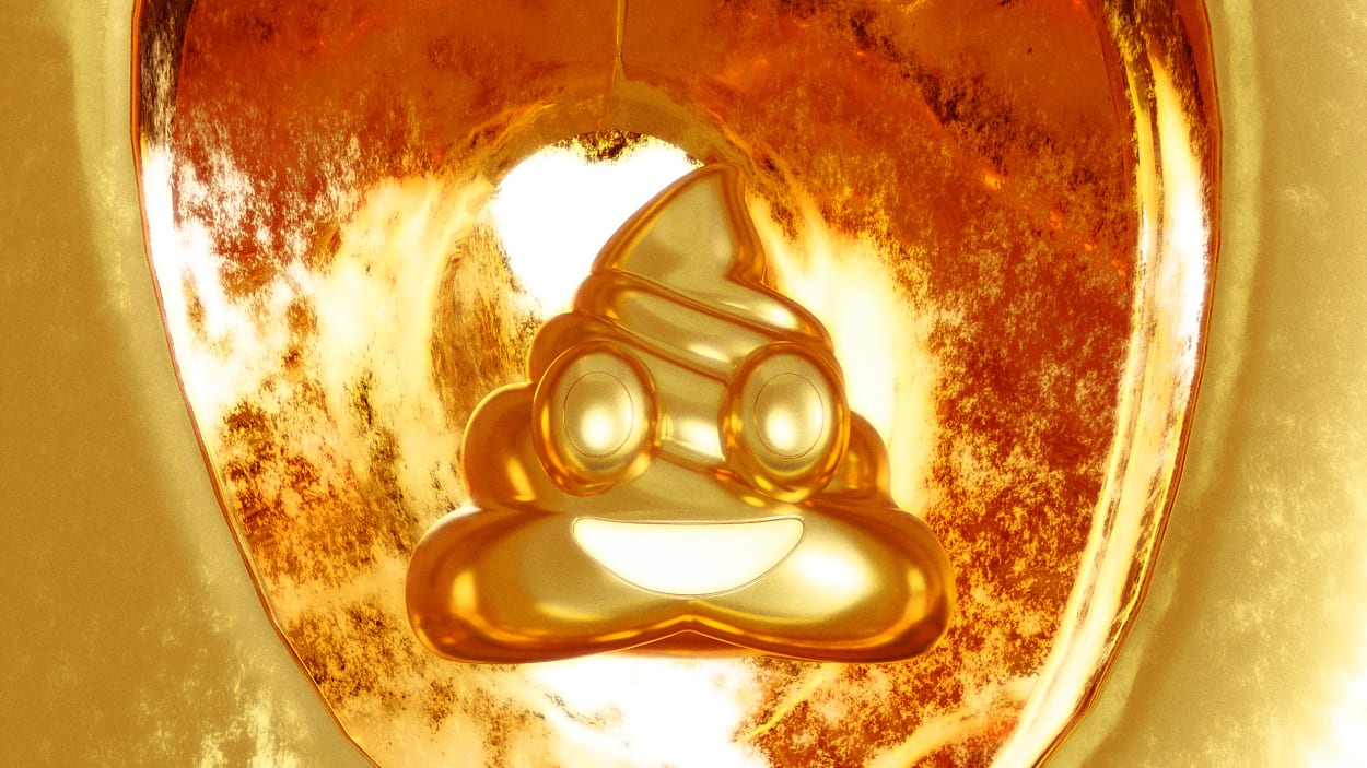 A golden poop emoji in a golden toilet