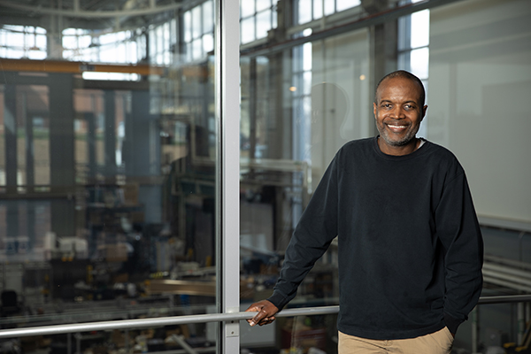 Comas Haynes standing in front of one of Georgia Tech's high bay research labs.