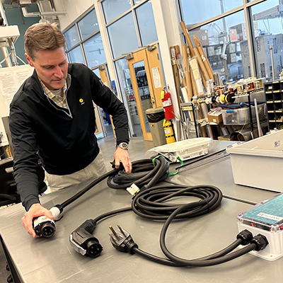 researcher examining a component of an EV.