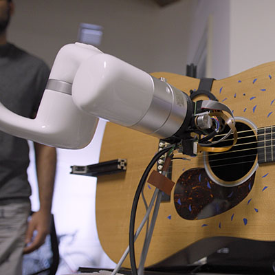 researcher examining a component of an EV.