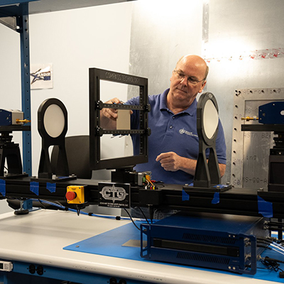 man in a blue workshort operating equipment in an industrial setting