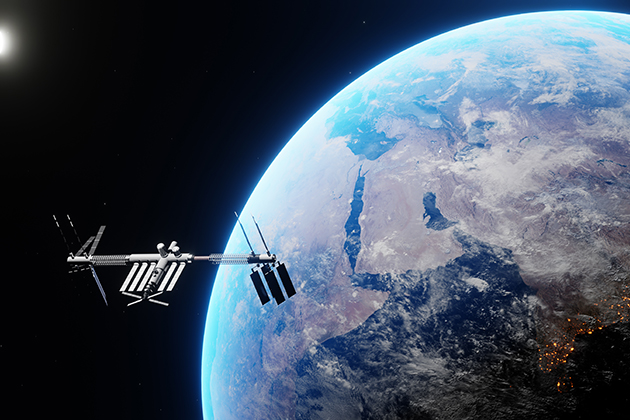 space station orbiting Earth with visible landmasses, glowing city lights, and a bright sun on the horizon against the blackness of space