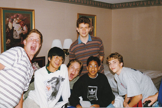 Group of six young boys posing with big, happy smiles