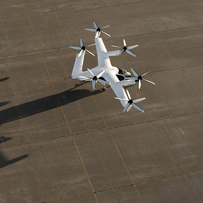 A large cluster of space debris, including broken satellites and panels, floating in Earth's orbit with the planet visible in the background.