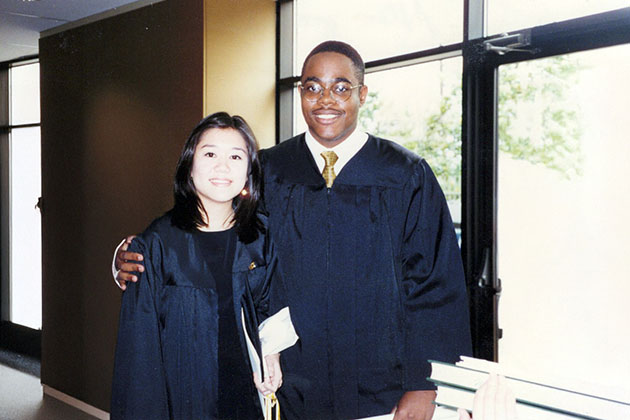 Male and female students wearing black graduation gowns