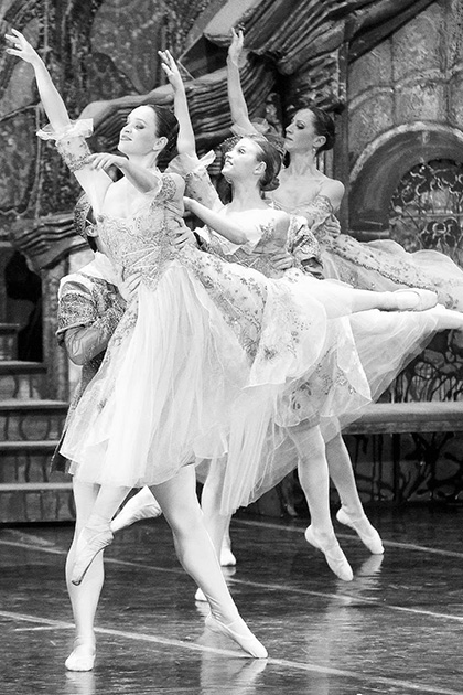black and white photo of three ballerinas in fancy costumes