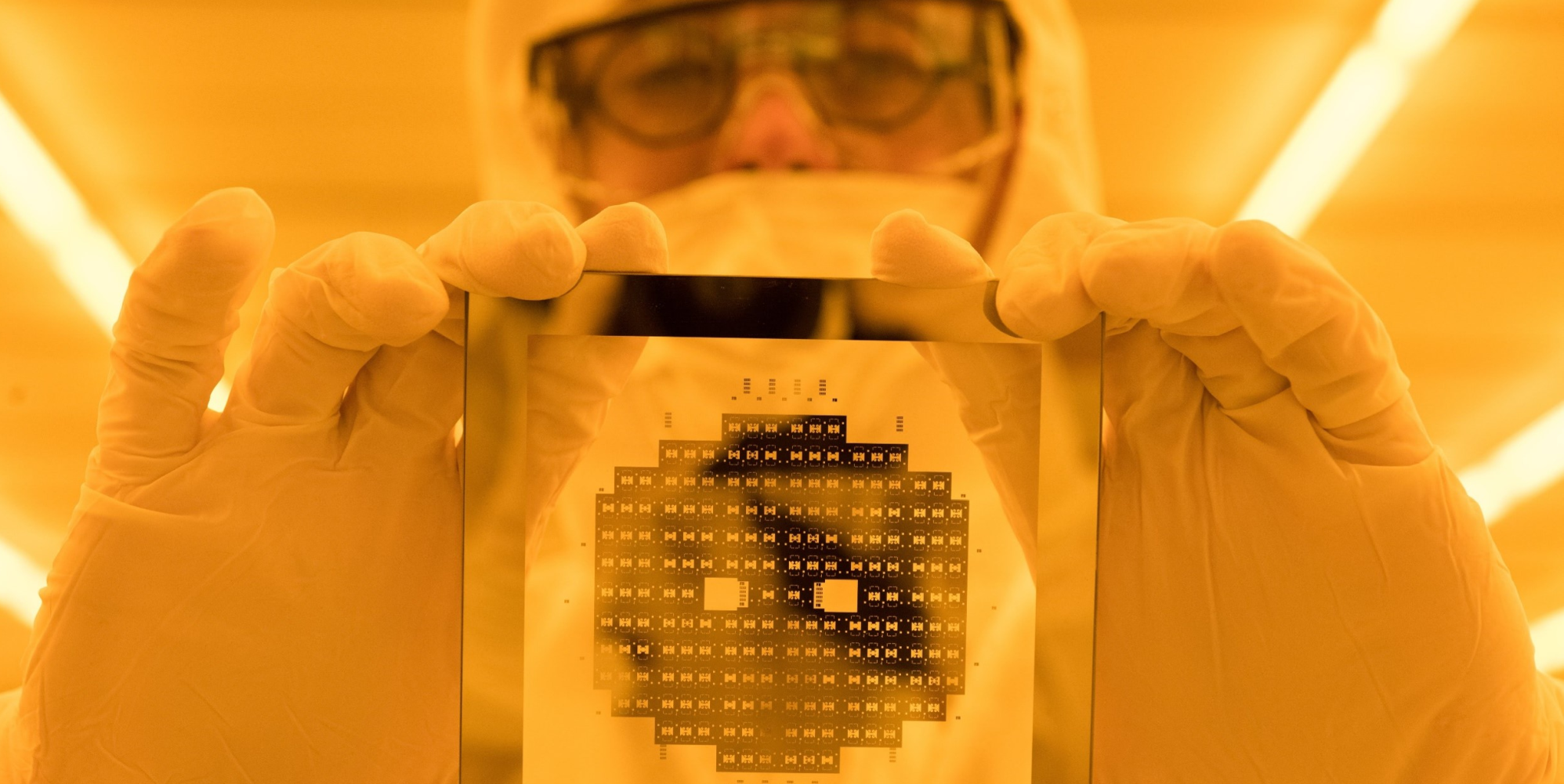 Devin Brown with etched Si wafer in the IEN Cleanroom