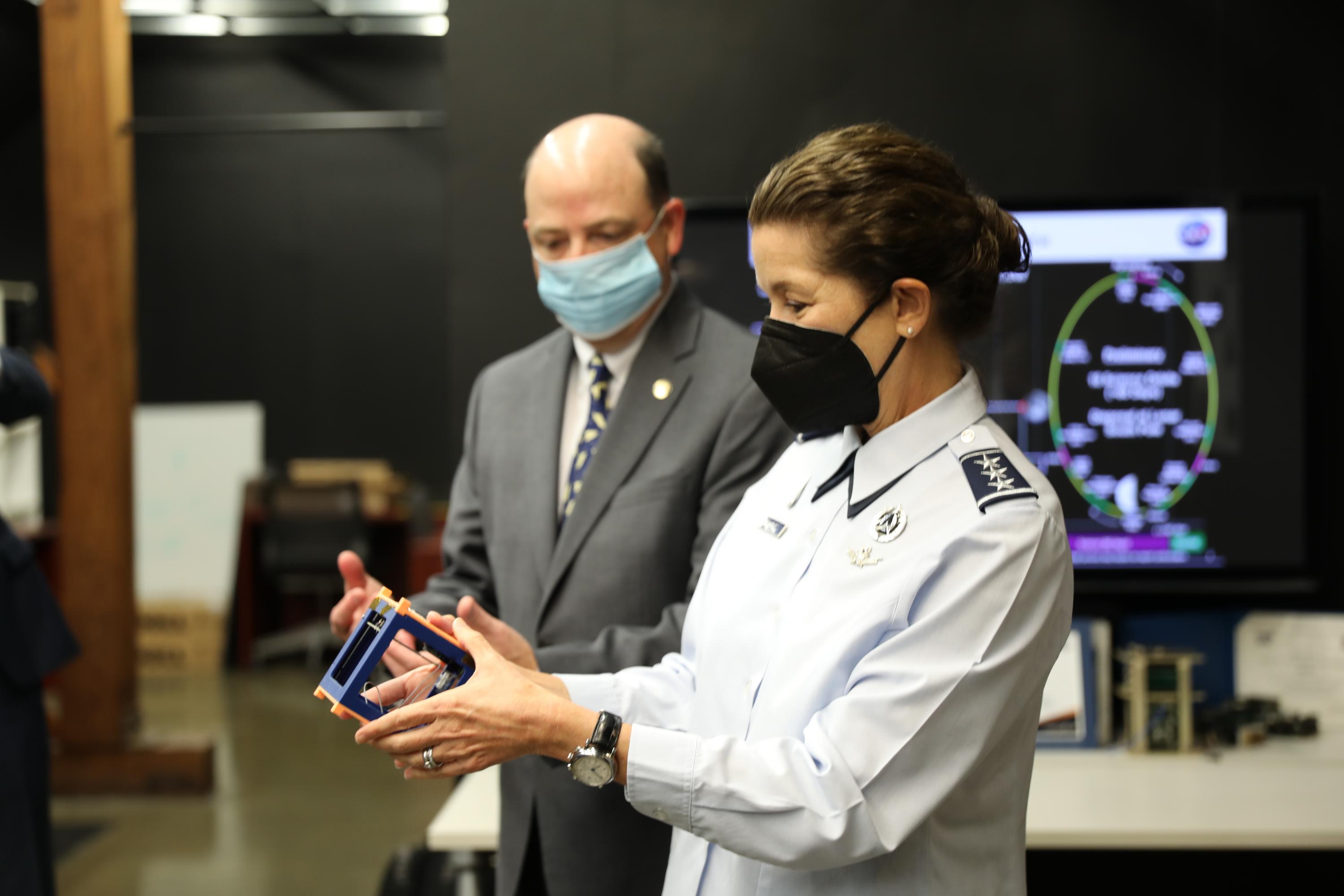 Lt. General Nina Armagno holds cubesat designed by the Space Systems Design Lab’s lab, led by professor Glenn Lightsey.