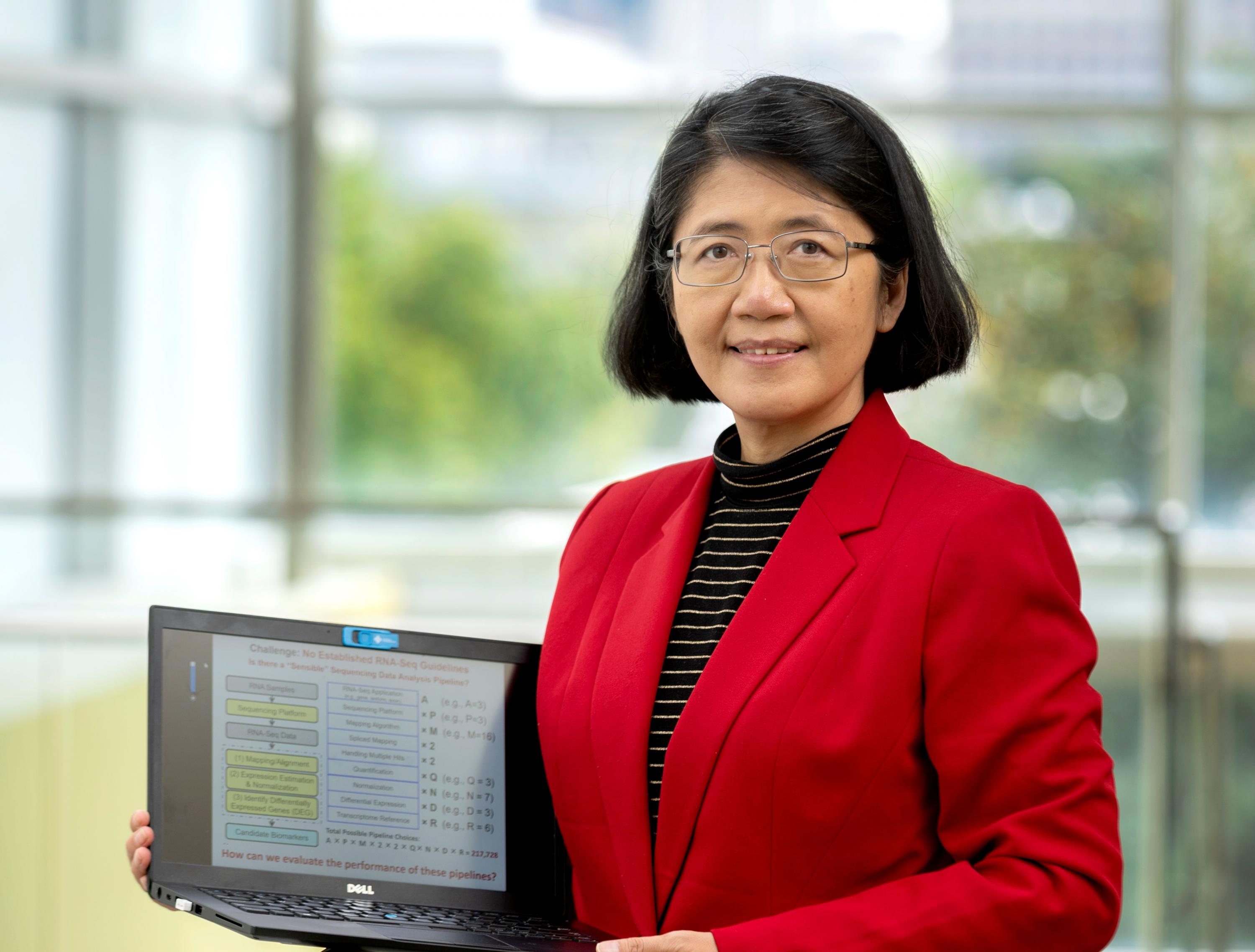 May Dongmei Wang, a professor in the Wallace H. Coulter Department of Biomedical Engineering at Georgia Tech and Emory University, shows a flowchart for evaluating sequencing. (Credit: Christopher Moore, Georgia Tech)