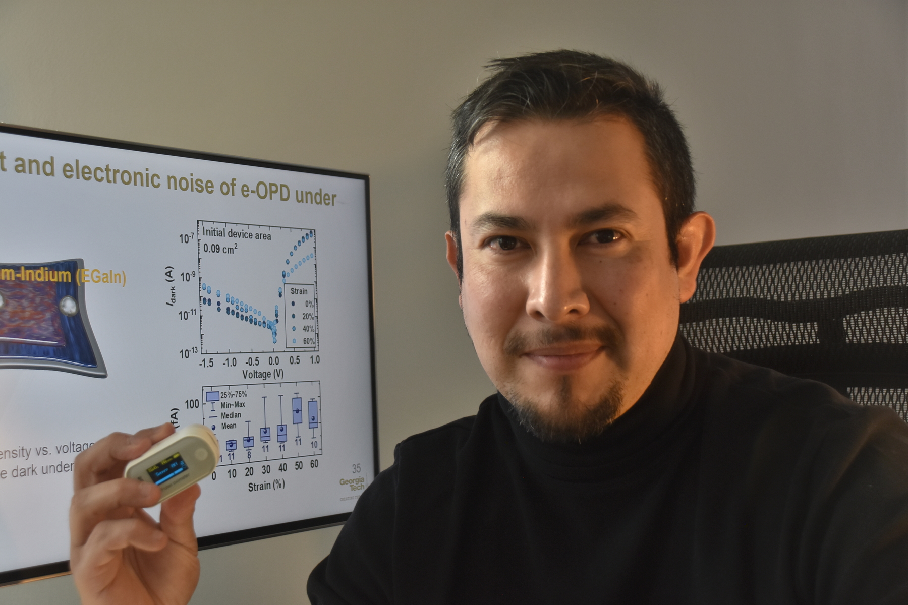 Prof. Canek Fuentes-Hernandez sees a great potential to use high-performance soft and stretchable photodetectors to enable pulse oximeters, like the one he is holding in his hand, to become more ergonomic and to consume less power. (Photo credit: Canek Fuentes-Hernandez)