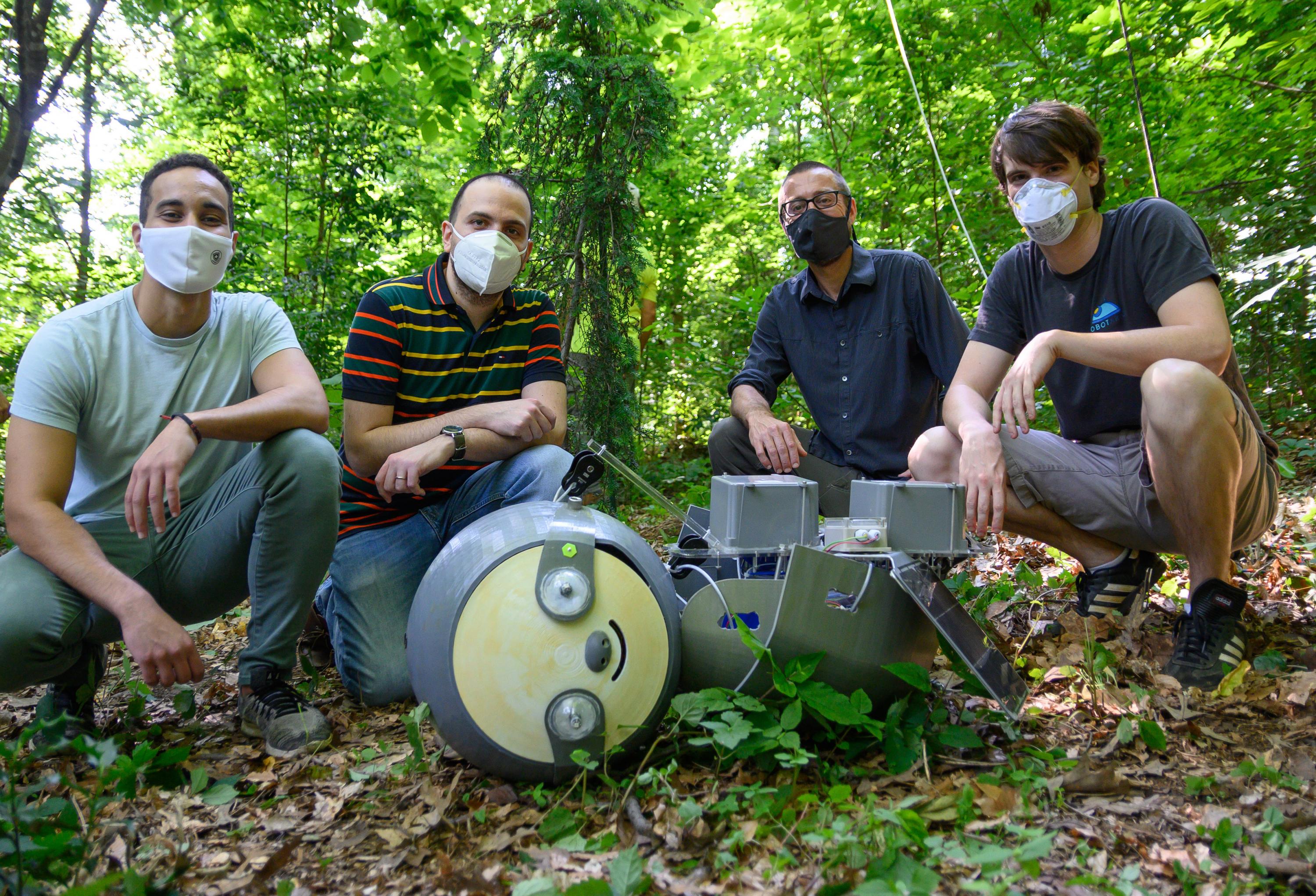 Georgia Tech researchers prepare to install the SlothBot at the Atlanta Botanical Garden. Shown are graduate research assistants Yousef Emam and Gennaro Notomista, Professor and School Chair Magnus Egerstedt, and Research Engineer Sean Wilson. (Credit: Rob Felt, Georgia Tech)