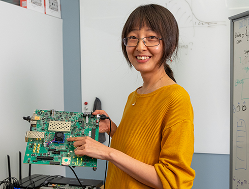 Callie Hao holds a FPGAA in a Georgia Tech nanotechnology lab.