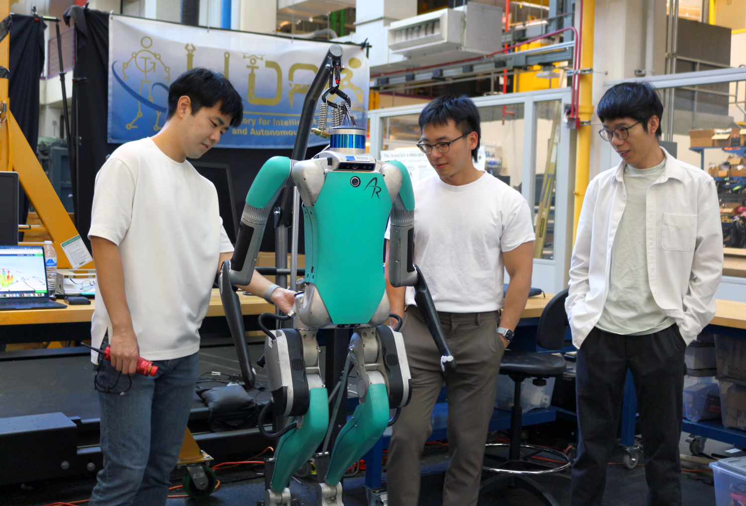 Members of the LIDAR Lab involved with the research with the DIGIT robot used in the trainings.