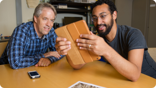 IRI faculty reviewing project on a tablet