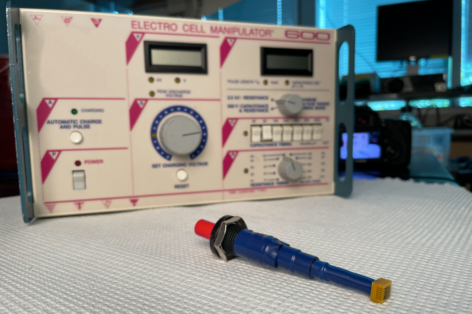 The photo above shows the dramatic size and complexity difference between Georgia Tech’s handheld ePatch device and a traditional electroporation machine that is the optimum way to deliver future DNA vaccines for Covid-19 and other viruses. (Photo credit: Candler Hobbs, Georgia Tech)