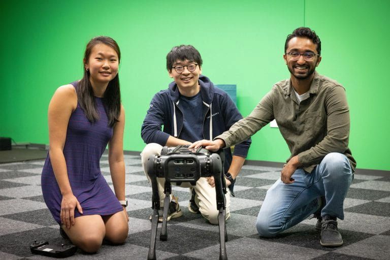 Joanne Truong, Naoki Yokoyama, and Simar Kareer with their robot star in the lab.