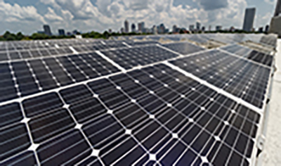 Image-link to Generation and Conservation. Image of solar panels on the roof of a building.