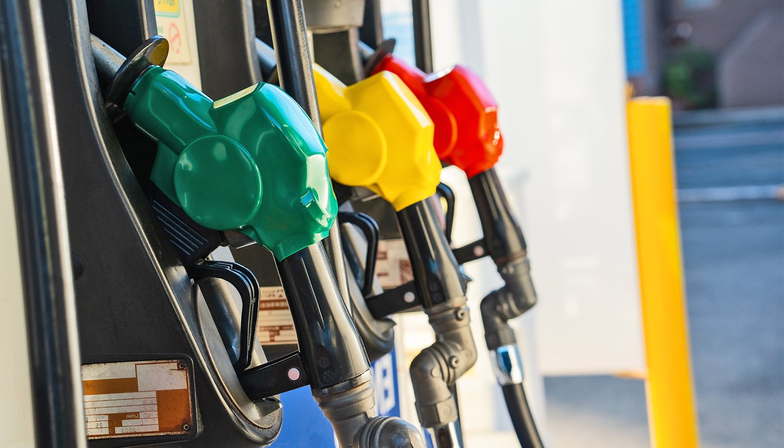 Gas station zooming in on the three different colored pumps