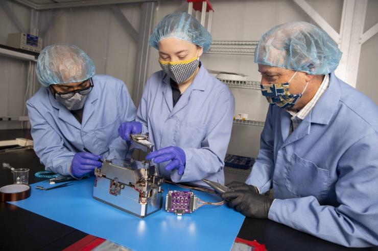 <p>Aerospace Engineering Professor Glenn Lightsey and graduate students Brandon Colón and Lacey Littleton assemble the propulsion system developed at Georgia Tech for the Lunar Flashlight CubeSat. (Credit: Candler Hobbs)</p>
