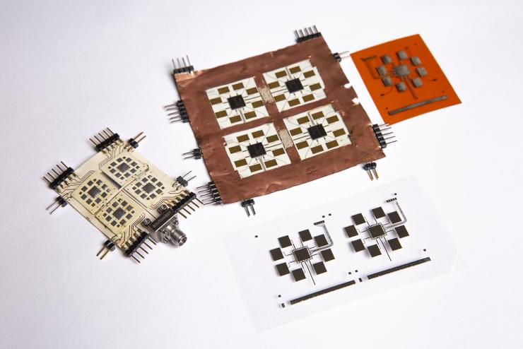 <p>Two fabricated proof-of-concept tile are shown alongside two inkjet-printed tile arrays, which the team will present on at the upcoming International Microwave Symposium in June.</p>