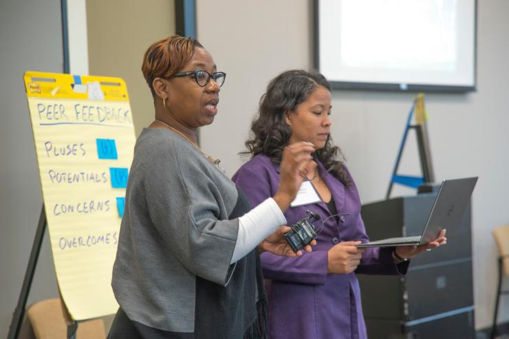 <p>Participants give presentations and seek peer feedback at the Negotiating the Digital and Data Divide Workshop. (from left) Velma Latson, lecturer at Bowie State University; Tasha Inniss, director of education and industry outreach at INFORMS.</p>