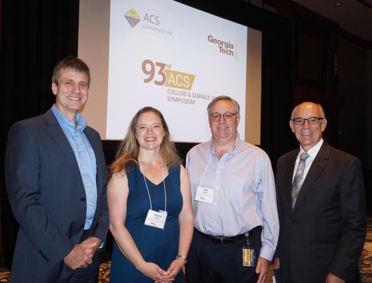 <p>Co-organizers of the symposium (i.e., the people who did the heavy lifting) are, left to right, Sven Behrens, Valeria Milam, and Seth Marder, seen here with Georgia Tech Provost Rafael Bras, who gave the opening address.</p>