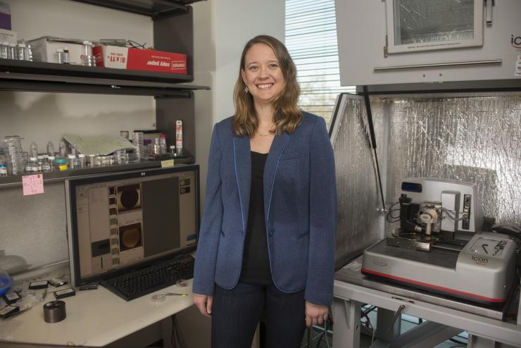 <p>Blair Brettmann has exposed dynamics of what makes polyelectrolyte brushes collapse and recover. The assistant professor at Georgia Tech's School for Material Sciences and Engineering is standing at an atomic force microscope (AFM) workstation. Credit: Georgia Tech / Christopher Moore</p>