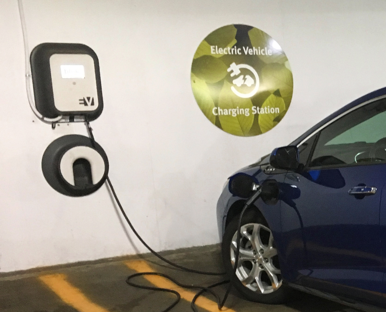 A dark blue electric car is plugged into a charger at an EV designated space in a parking structure. &lt;a href=&quot;https://commons.wikimedia.org/wiki/File:Chevy_Volt_2nd_gen_charging_Arlington_08_2017_5216.jpg&quot;&gt;Mariordo (Mario Roberto Durán Ortiz)&lt;/a&gt;, &lt;a href=&quot;https://creativecommons.org/licenses/by-sa/4.0&quot;&gt;CC BY-SA 4.0&lt;/a&gt;, via Wikimedia Commons