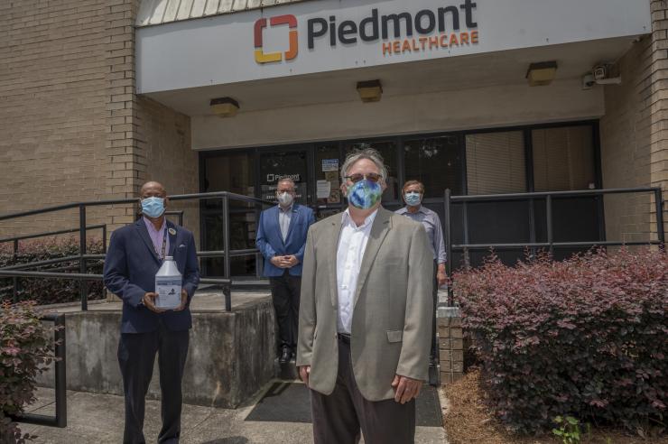 <p>The heroes who redesigned hand sanitizer and donated 7,000 gallons of their own brand to hospitals and nursing homes. From left to right: George White, Chris Luettgen, Seth Marder, and Atif Dabdoub. Here at a delivery to Piedmont Healthcare of Atlanta. Credit: Georgia Tech / Christopher Moore</p>