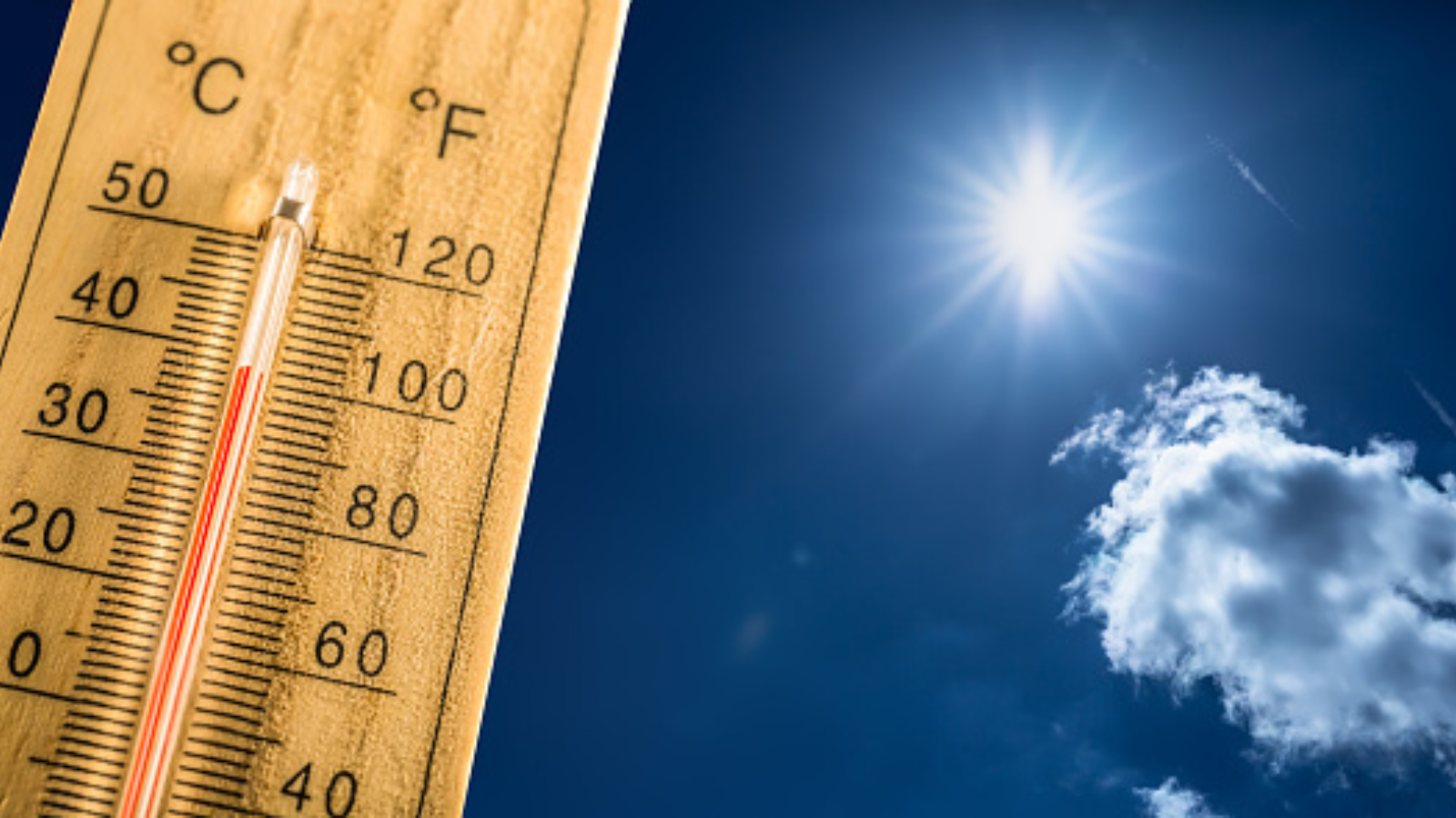 stock photo of a thermometer with a high temperature and a sunny sky behind it