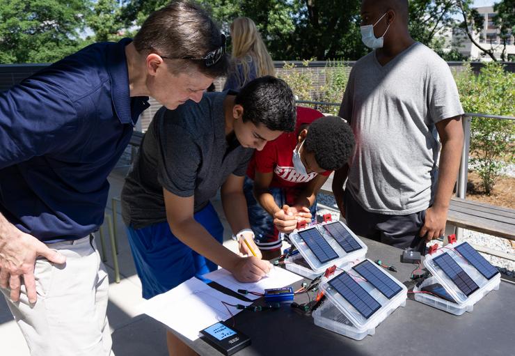 <p>Students of the 2021 "Energy Unplugged" summer STEAM camp recording data from a small solar test kit.</p>