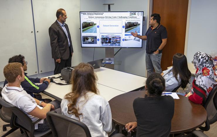 <p>ECE Professor Ghassan AlRegib and postdoctoral research fellow Mohit Prabhushankar discussing the group’s latest machine learning work in autonmous vechicles (AVs). AVs are one of the most obvious examples of OLIVES research in every day life. </p>