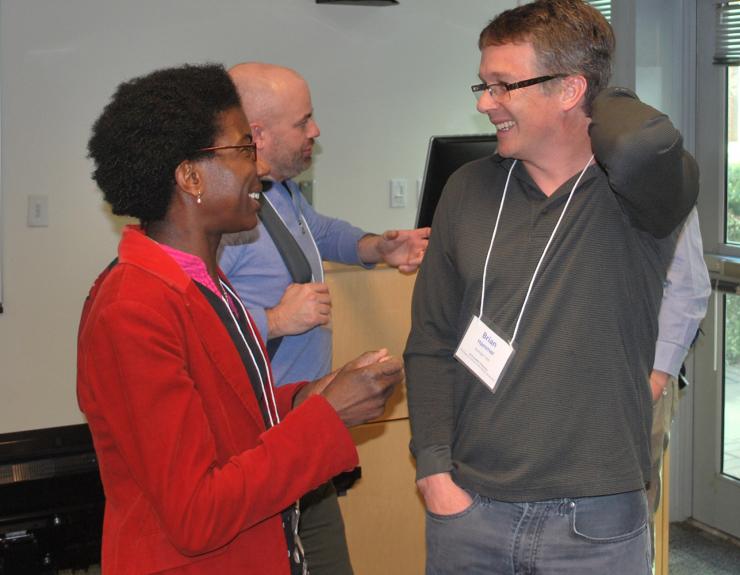 <p>Karine Gibbs of Harvard and Symposium co-chair Brian Hammer enjoy a post-presentation laugh.</p>