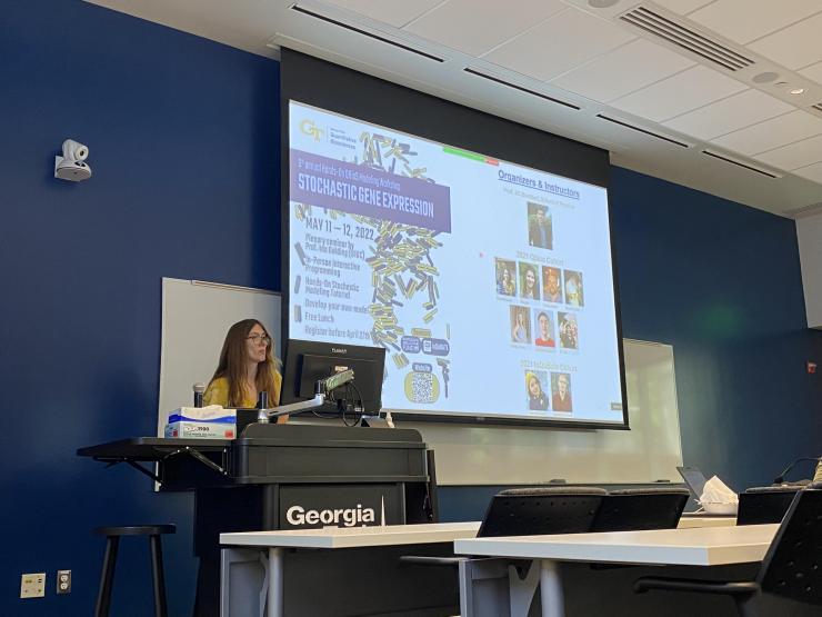 <p>Adriana Lucia-Sanz, postdoctoral researcher in the Weitz Group at Georgia Tech, which is led by Joshua Weitz, professor and Tom and Marie Patton Chair of Biological Sciences and founding director of the Quantitative Biosciences program, delivering the opening lecture.</p>