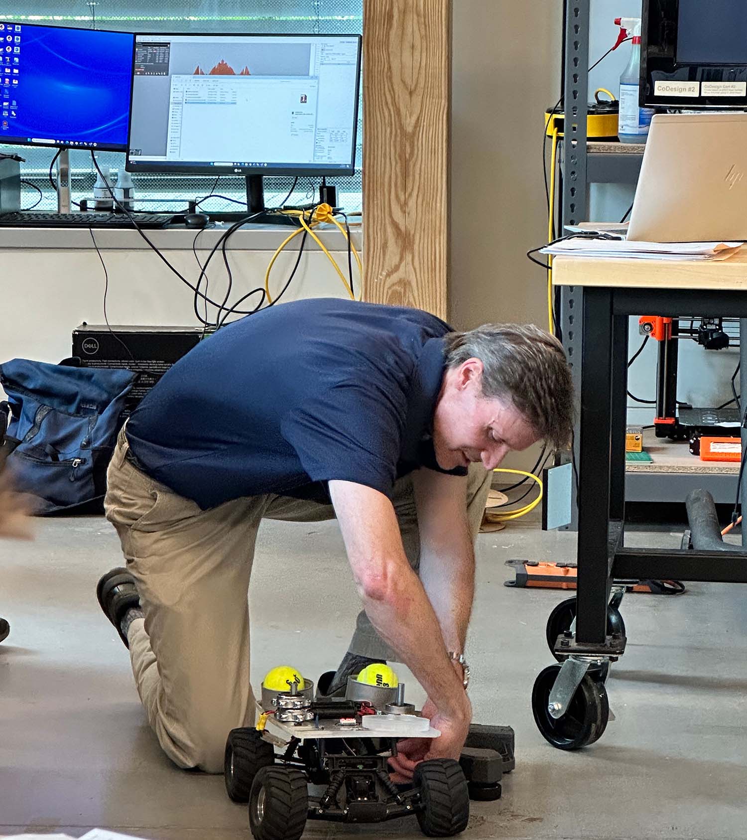 Rich Simmons showing the RC car demo to parents during the final day presentation