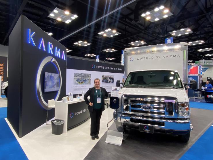 Jenn Voelker showcasing Karma&#039;s commerical product line at an auto show. 