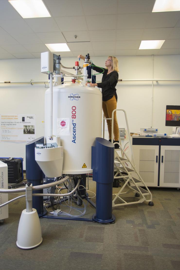 Principal investigator Julia Kubanek loads a sample into a nuclear magnetic resonance spectroscopy device. Georgia Tech / Christopher Moore
