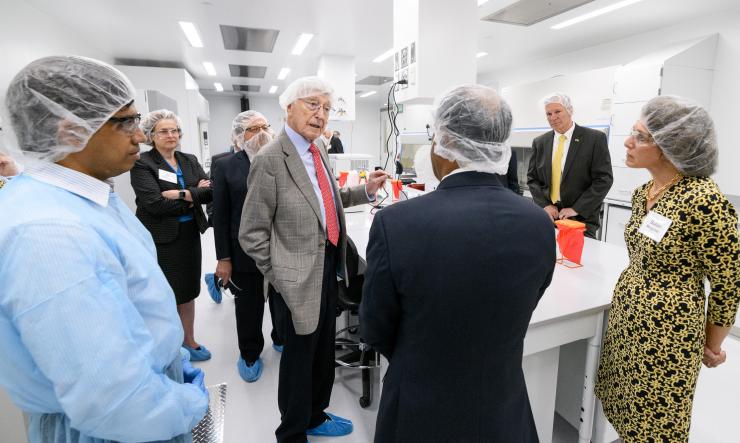 <p>Philanthropist Bernie Marcus makes a point during a tour of the new Good Manufacturing Practice (GMP) like facility that is part of the Marcus Center for Therapeutic Cell Characterization and Manufacturing (MC3M). (Credit: Rob Felt, Georgia Tech)</p>