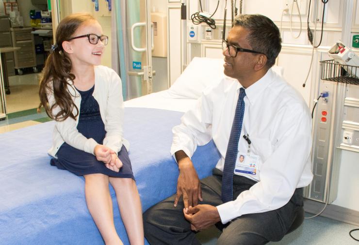 <p>Subra Kugathasan, M.D., Emory University principal investigator and lead author of the paper, is shown with Evelyn Whitaker, who was eight years old when the photo was taken. (Credit: Children’s Healthcare of Atlanta).</p>