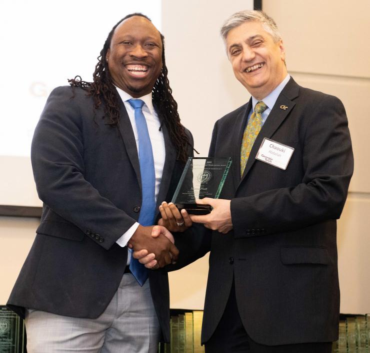 <p>Manu Platt accepts his award from Chaouki T. Abdallah, Georgia Tech's executive vice president of research.</p>