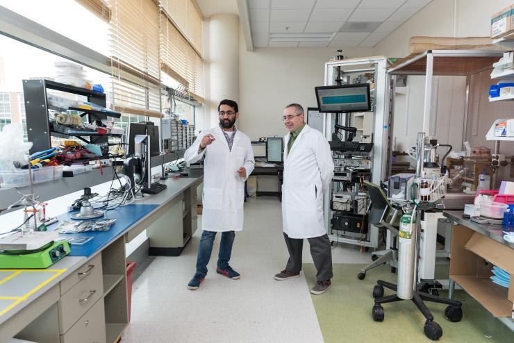 <p>Leader researcher Yogi Patel (left) and principal investigator Robert Butera in Butera's lab on Georgia Tech's campus at the <em>Wallace H. Coulter Department of Biomedical Engineering at Georgia Tech and Emory University</em>. Credit: Georgia Tech / Rob Felt</p>