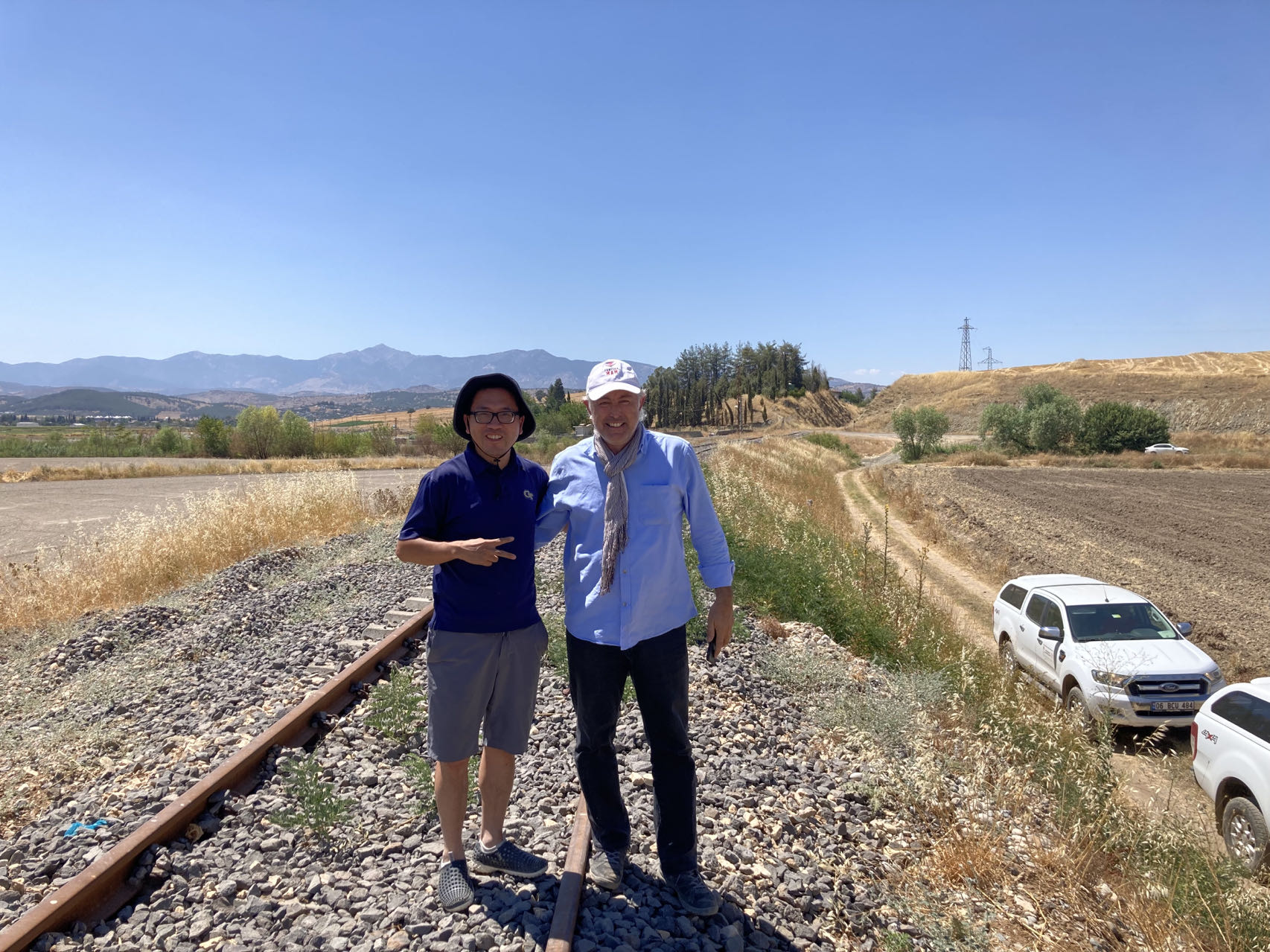 Georgia Tech scientist Zhigang Peng posing with TUBITAK scientist Ekrem Zor right in front of a possible surface rupture produced by the 2023 magnitude 7.8 earthquake