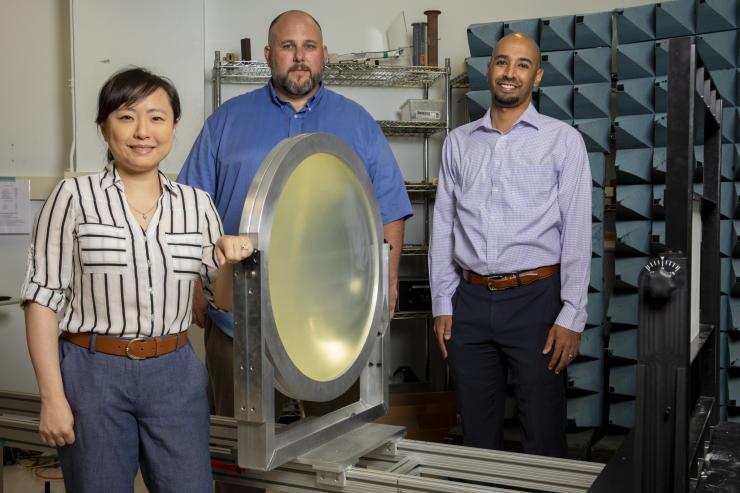<p>(L to R) Ellen Yi Chen Mazumdar, Aaron Stebner, and Anirban Mazumdar, PIs for Georgia Tech's recently awarded UCAH grants, stand next to a free-space focused beam characterization system for studying radome materials that can be used for hypersonics. Not pictured: Jonathan Rogers. (Photo credit: Sam McNeil, GTRI)</p>