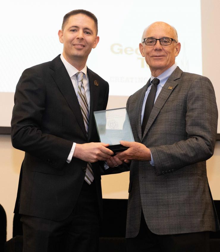 <p>Chris Rozell accepts his award from Georgia Tech Provost Rafael Bras.</p>