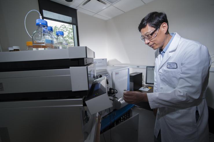 <p>Researcher Ronghu Wu analyzes complex polymers using rarely accessible spectrophotometric technology available in his lab at Georgia Tech. Credit: Georgia Tech / Christopher Moore</p>